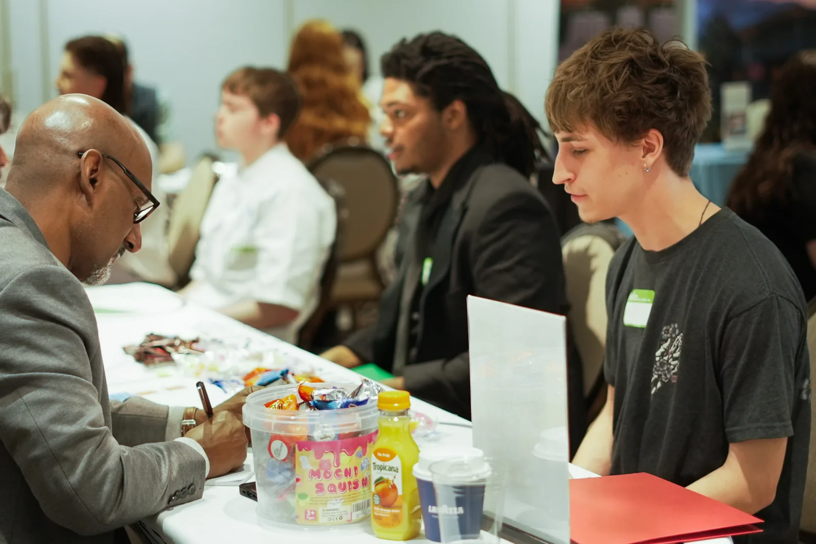 A young man interviews across the table from local employers at Draft Day.