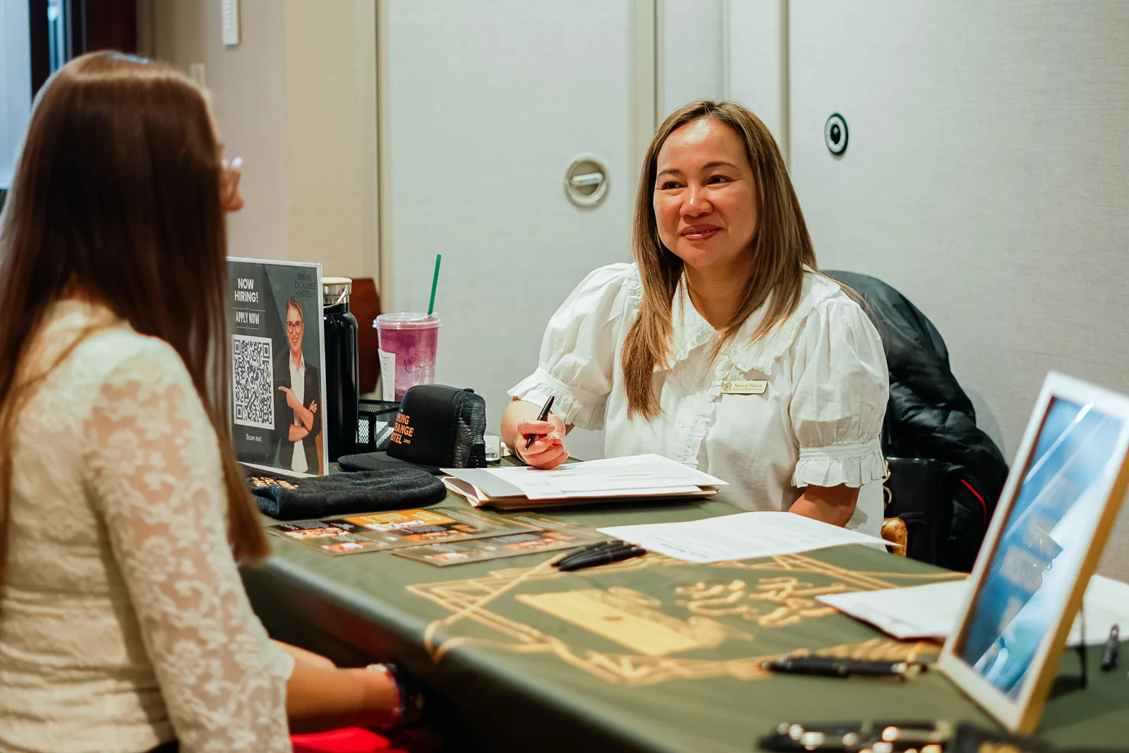 A local employer smiles while interviewing a student at Draft Day.