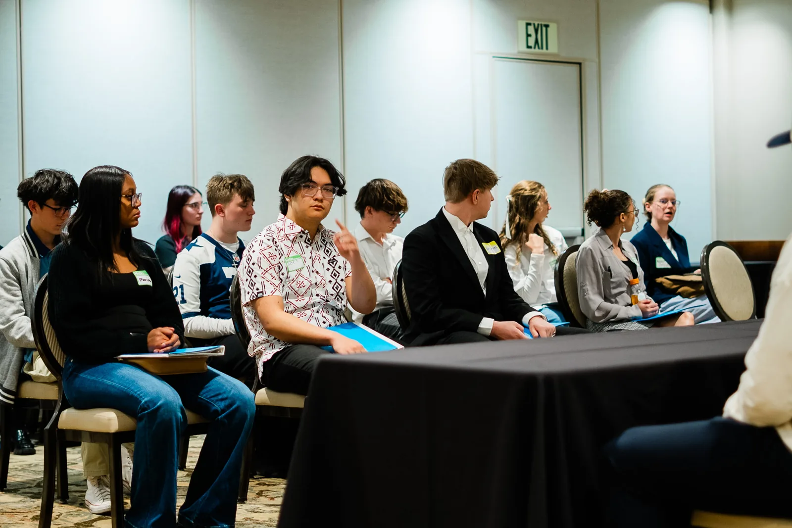 Students dressed for interviews wait together at a Jumpstart Draft Day.